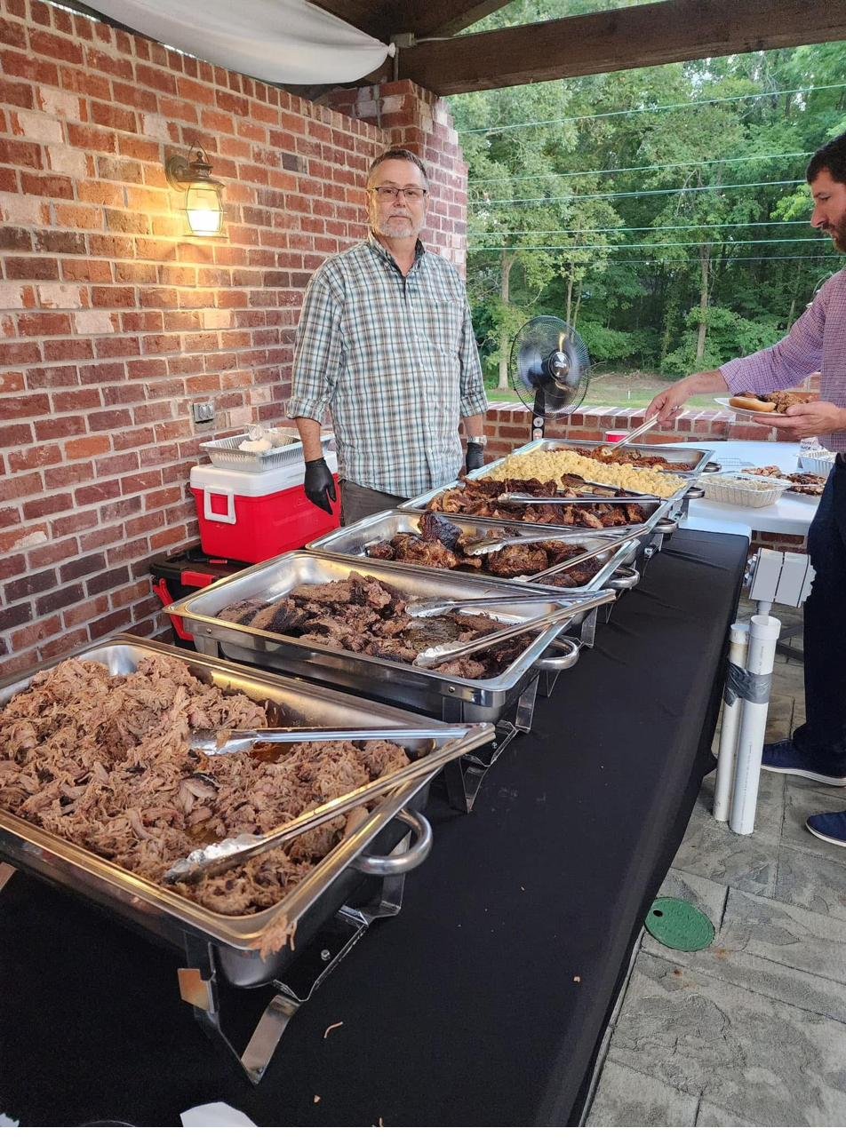 Nick Hess — owner and pitmaster — serving a wedding buffet