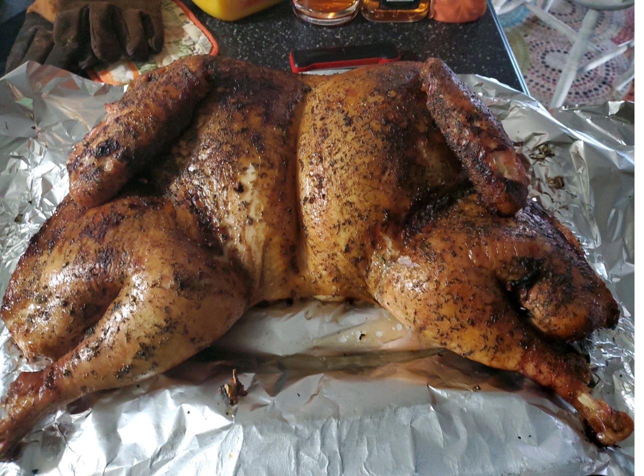 Whole smoked turkey on aluminum foil