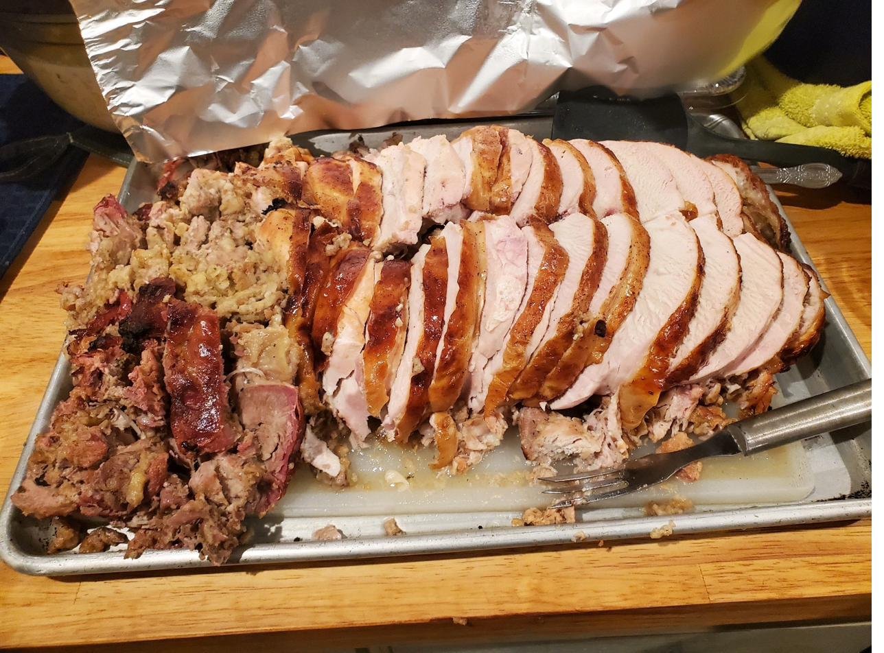 Sliced smoked turkey breast with stuffing and ham